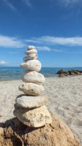 Aufeinandergestapelte Steine am Strand von Sardinien, historische Aufnahme von 2013