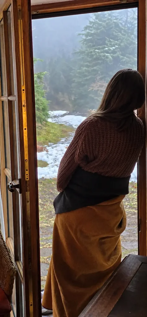 Achtsamer Blick aus der Bergbaude in die verschneite Natur